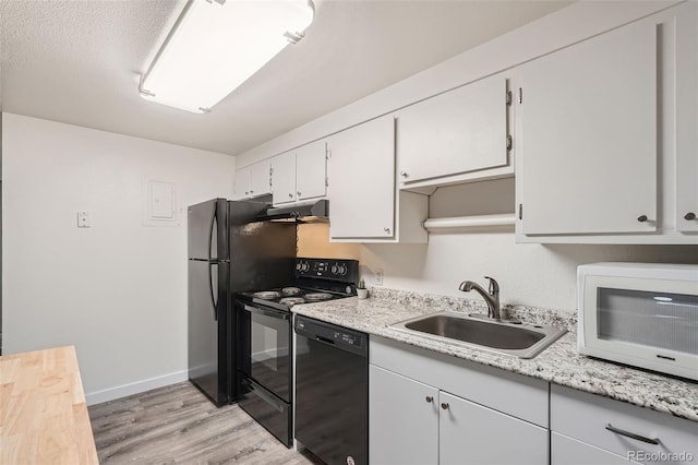 kitchen featuring black appliances, light hardwood / wood-style floors, a textured ceiling, white cabinetry, and sink