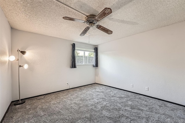 carpeted empty room with a textured ceiling and ceiling fan