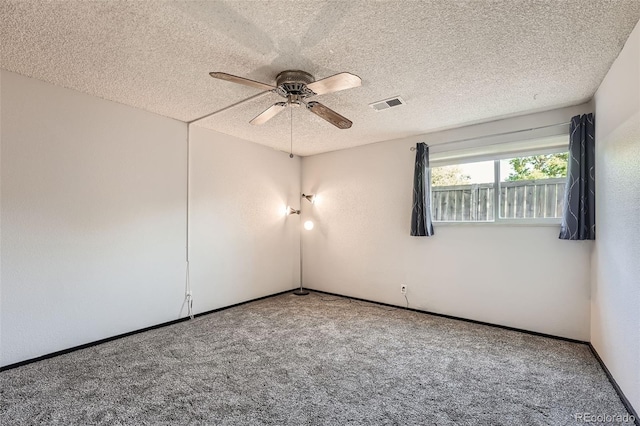 unfurnished room featuring a textured ceiling, ceiling fan, and carpet