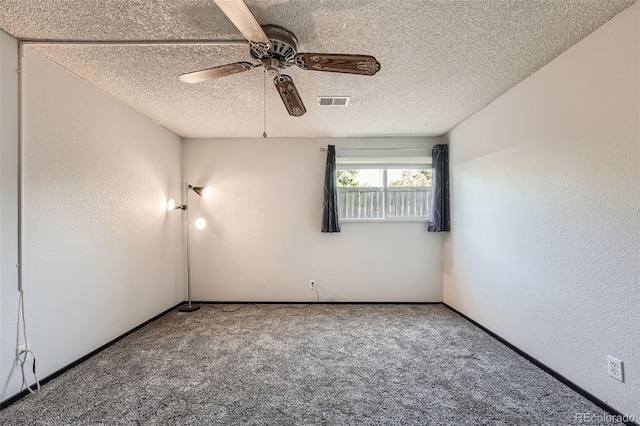 spare room featuring a textured ceiling, ceiling fan, and carpet