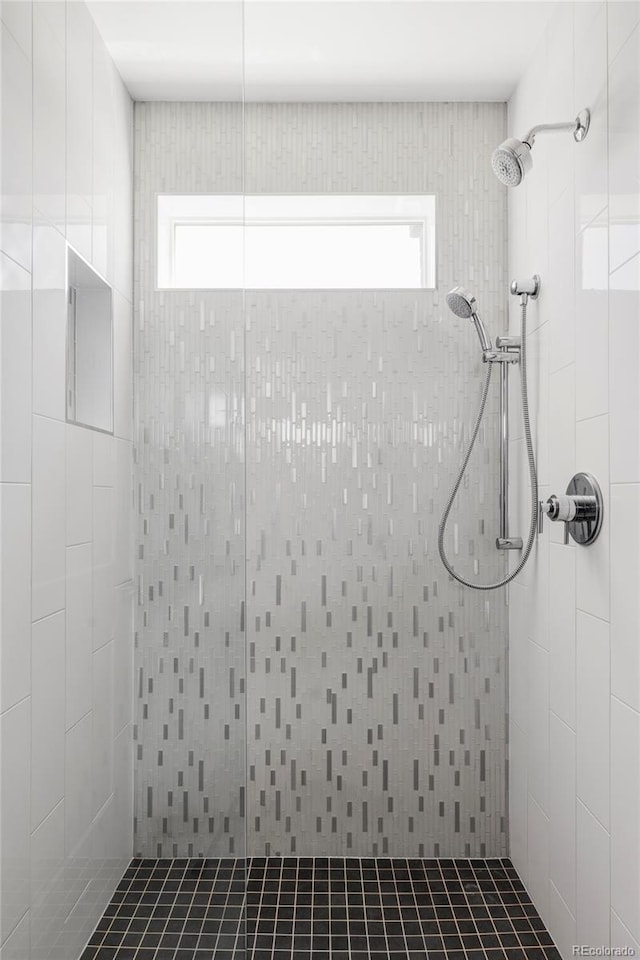 1457 Yates St, Denver, CO 80204 - bathroom featuring a tile shower and plenty of natural light
