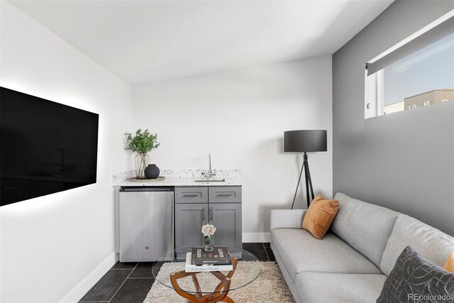 1457 Yates St, Denver, CO 80204 - living area featuring bar with sink and dark tile patterned floors