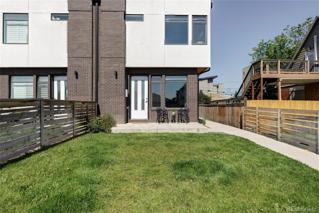 1457 Yates St, Denver, CO 80204 - back of property featuring brick siding, stucco siding, a fenced backyard, and a patio