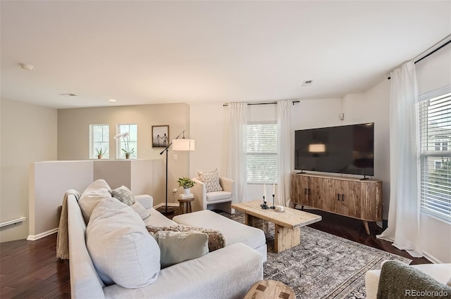 living room featuring a wealth of natural light and dark hardwood / wood-style floors