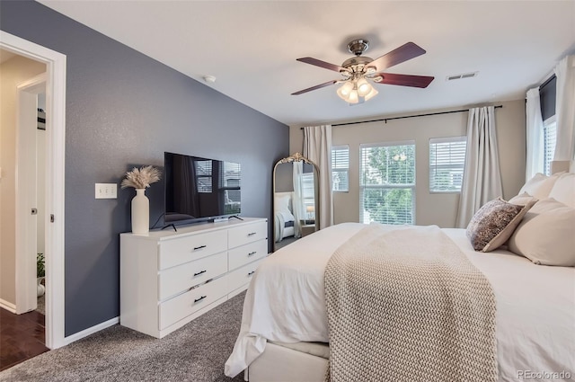 bedroom with dark colored carpet and ceiling fan