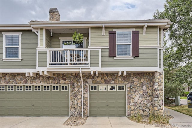 view of front of home featuring a balcony and a garage