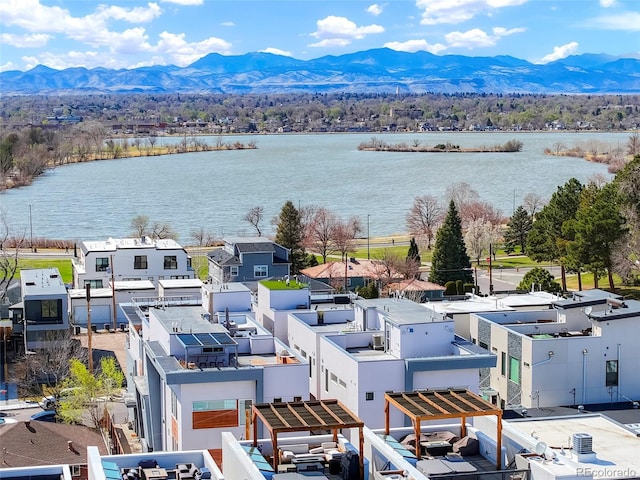 drone / aerial view featuring a water and mountain view