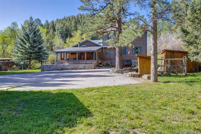 11531 S Deer Creek Rd, Littleton, CO 80127 - rear view of property featuring a porch and a view of trees