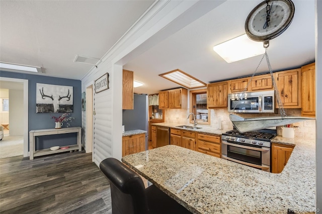 11531 S Deer Creek Rd, Littleton, CO 80127 - kitchen with stainless steel appliances, tasteful backsplash, light stone countertops, and dark wood-style floors