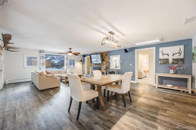 11531 S Deer Creek Rd, Littleton, CO 80127 - dining space with a baseboard radiator, a ceiling fan, and wood finished floors