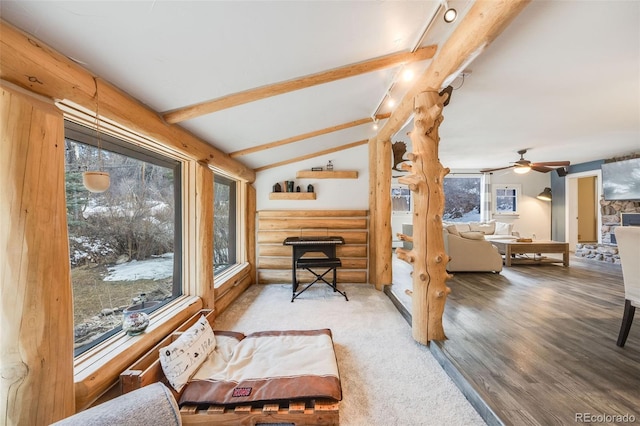 11531 S Deer Creek Rd, Littleton, CO 80127 - sitting room featuring log walls, a ceiling fan, and wood finished floors