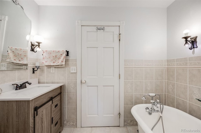 11531 S Deer Creek Rd, Littleton, CO 80127 - full bathroom with tile walls, a freestanding bath, vanity, wainscoting, and tile patterned flooring
