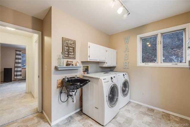 11531 S Deer Creek Rd, Littleton, CO 80127 - laundry area with cabinet space, washer and dryer, and track lighting
