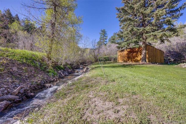 11531 S Deer Creek Rd, Littleton, CO 80127 - view of green lawn with a view of trees