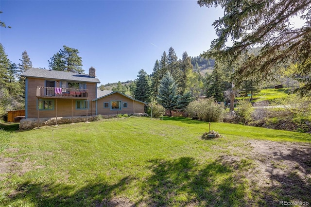 11531 S Deer Creek Rd, Littleton, CO 80127 - view of green lawn with a wooden deck