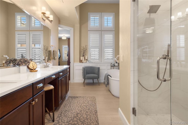 bathroom featuring shower with separate bathtub, vanity, and hardwood / wood-style floors