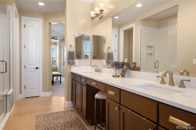 bathroom featuring hardwood / wood-style flooring, vanity, and an enclosed shower