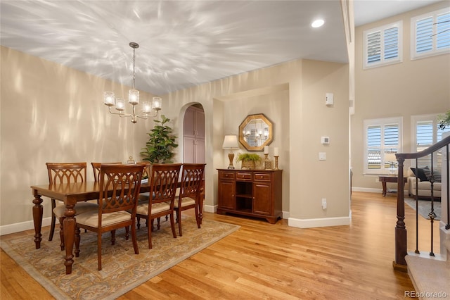 dining area featuring light hardwood / wood-style floors and an inviting chandelier