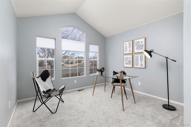 carpeted office space with visible vents, vaulted ceiling, and baseboards