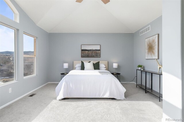 carpeted bedroom with a ceiling fan, visible vents, vaulted ceiling, and baseboards