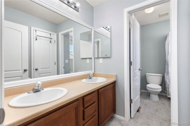 full bathroom with visible vents, a sink, toilet, and double vanity