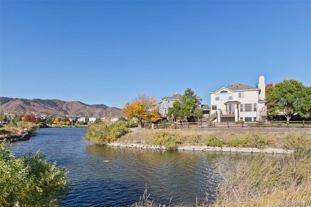 water view featuring fence and a mountain view