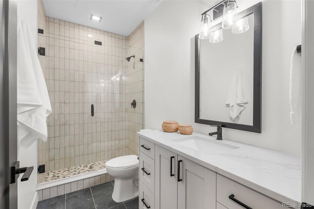 bathroom featuring tile patterned floors, a shower stall, toilet, and vanity