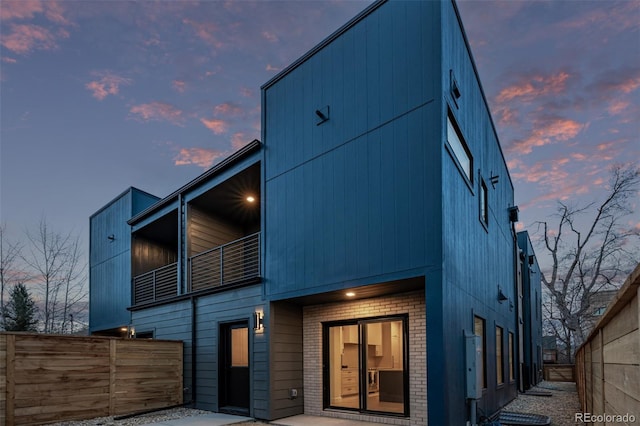 535 Josephine St, Denver, CO 80206 - back of house at dusk featuring brick siding and a balcony