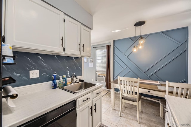 kitchen featuring decorative light fixtures, black dishwasher, white cabinetry, and sink