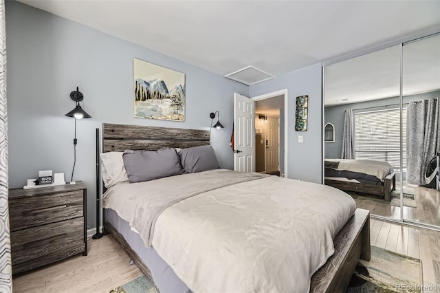 bedroom with a closet and light hardwood / wood-style floors