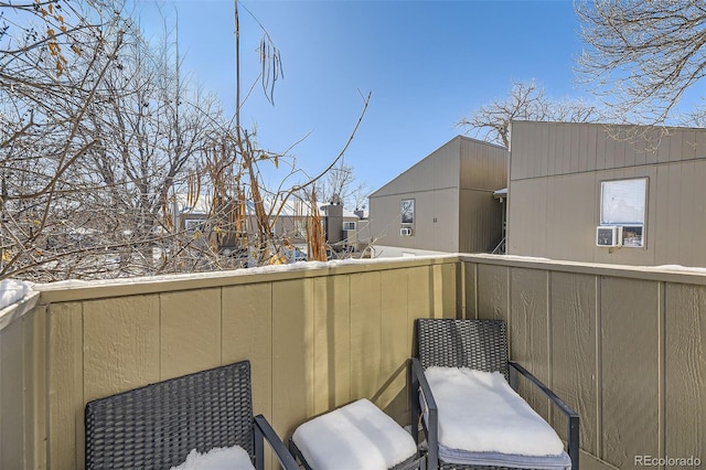 view of snow covered back of property