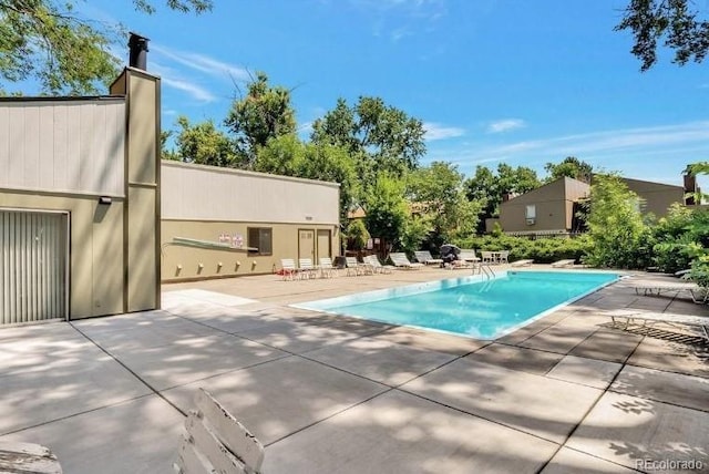 view of swimming pool with a patio