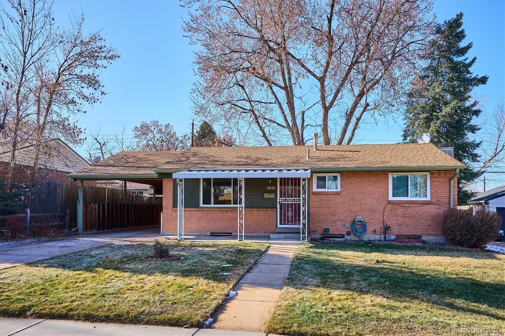 view of front of home featuring covered porch, a front yard, and a carport