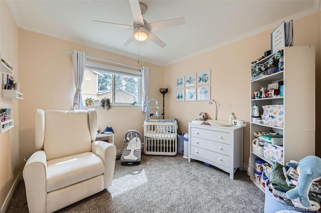 bedroom with ceiling fan, baseboards, carpet floors, ornamental molding, and a nursery area