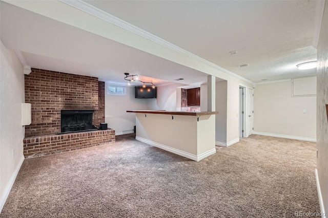 unfurnished living room featuring a brick fireplace, ornamental molding, baseboards, and light carpet