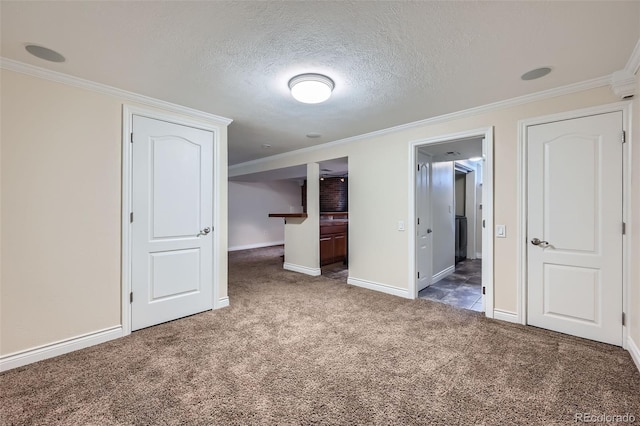 unfurnished bedroom featuring a textured ceiling, crown molding, and carpet