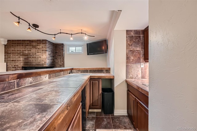 bar featuring indoor bar and a textured wall