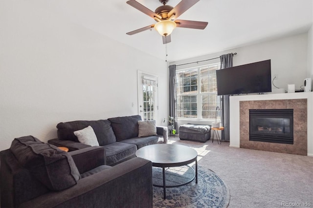 17388 Nature Walk Trl Unit 202, Parker, CO 80134 - carpeted living area featuring a tiled fireplace and a ceiling fan