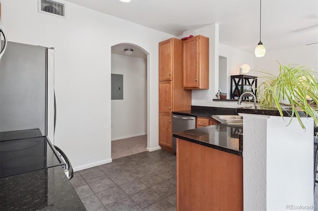 17388 Nature Walk Trl Unit 202, Parker, CO 80134 - kitchen with range, a peninsula, freestanding refrigerator, arched walkways, and electric panel