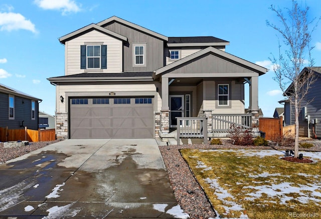 craftsman-style home with a lawn, a porch, and a garage