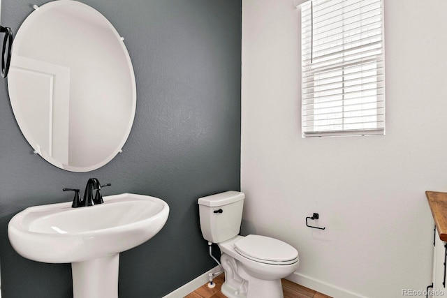 bathroom featuring hardwood / wood-style flooring, sink, and toilet