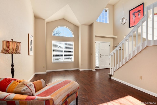 entryway with a notable chandelier, dark hardwood / wood-style floors, and a high ceiling