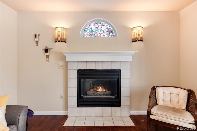 details featuring hardwood / wood-style floors and a tile fireplace