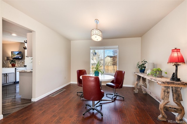 dining room with dark hardwood / wood-style floors