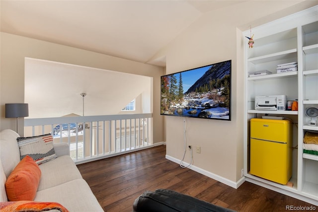 living room with lofted ceiling, built in features, and dark hardwood / wood-style flooring