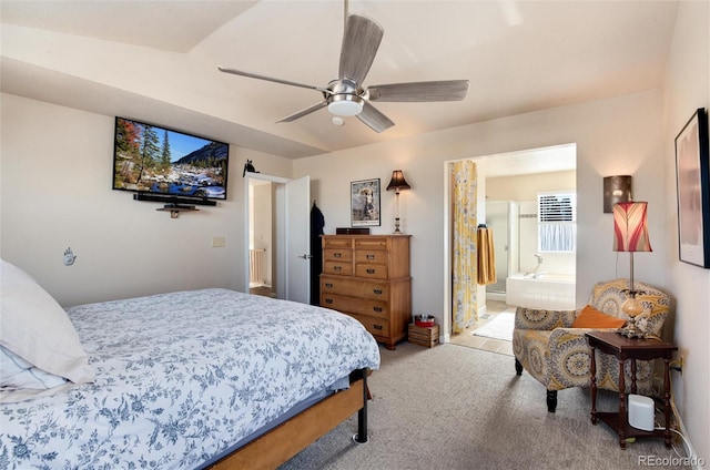 bedroom featuring light colored carpet, ceiling fan, and ensuite bath