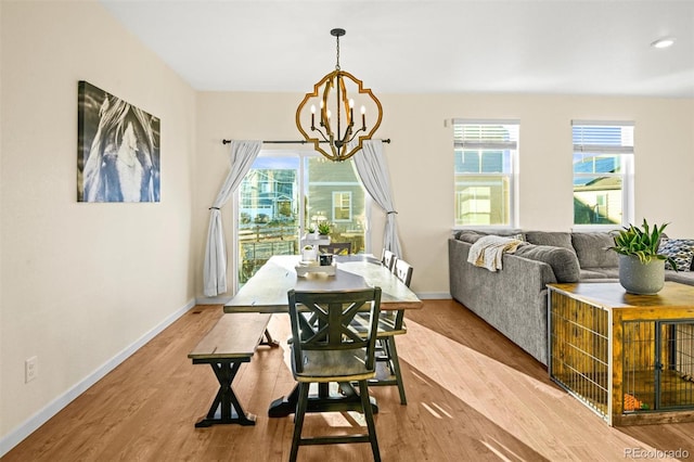 dining space with a chandelier and light wood-type flooring