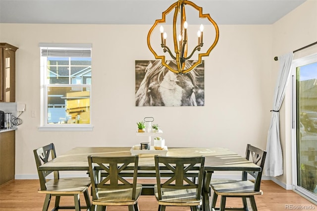 dining space with a chandelier and light wood-type flooring