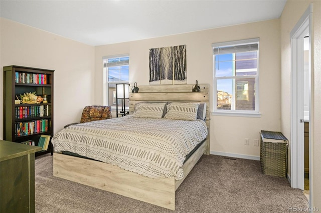 bedroom with carpet flooring and multiple windows