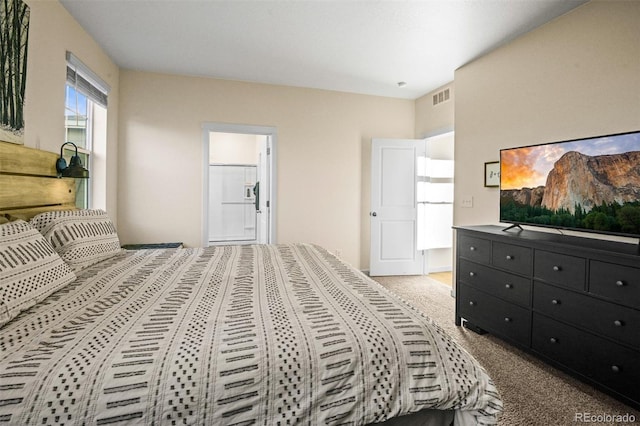 bedroom featuring light colored carpet